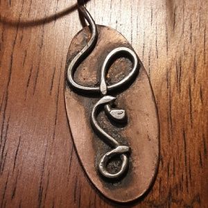 Handmade copper and silver snake pendant.